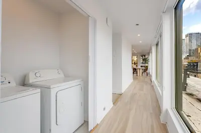 a laundry room with white appliances and a window at Montreal Downtown Haven, Walk to All Attractions in Montréal