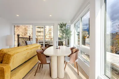 a living room with a table and chairs and a couch at Montreal Downtown Haven, Walk to All Attractions in Montréal
