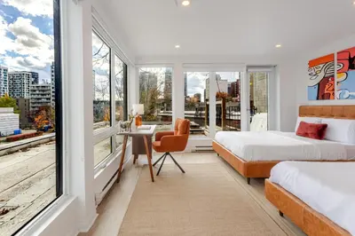 a bedroom with two beds and a window at Montreal Downtown Haven, Walk to All Attractions in Montréal