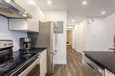 a kitchen with a stainless steel refrigerator and a stove at Chic City Hideaway, Vibrant Heart of Montreal in Montréal