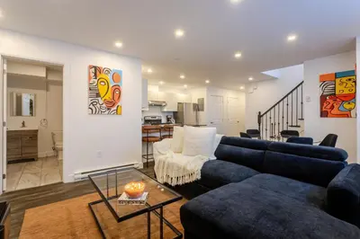 a living room with a blue couch and a table at Chic City Hideaway, Vibrant Heart of Montreal in Montréal