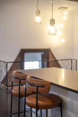 a group of stools at a table in a room at Elegant Downtown Stay, Near Bell Centre MTL in Montréal