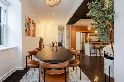 a kitchen and dining room with a table and chairs at Elegant Downtown Stay, Near Bell Centre MTL in Montréal