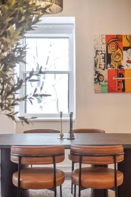 a dining room table with chairs and a window at Elegant Downtown Stay, Near Bell Centre MTL in Montréal