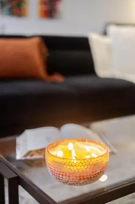 an orange bowl on a table with a book at Elegant Downtown Stay, Near Bell Centre MTL in Montréal