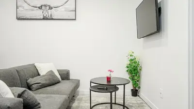 a living room with a couch and a table at Appartement charmant proche des attractions in Montréal