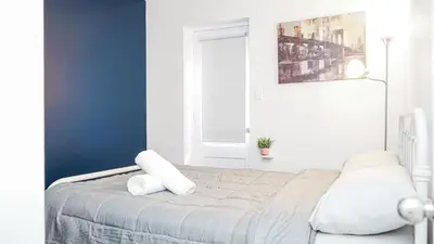 a bedroom with a bed with two pillows on it at Appartement charmant proche des attractions in Montréal