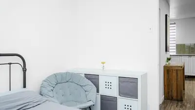 a bedroom with a desk and a chair next to a bed at Appartement charmant proche des attractions in Montréal