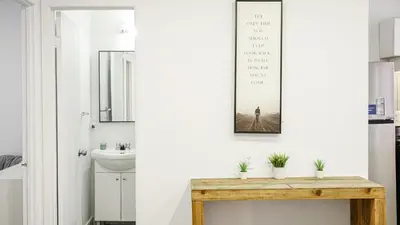 a bathroom with a sink and a mirror at Appartement charmant proche des attractions in Montréal