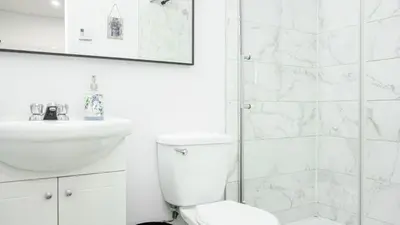 a bathroom with a toilet and a sink and a shower at Appartement charmant proche des attractions in Montréal