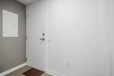 a room with two white doors and a wall at Studio paisible et central-Montréal in Montréal
