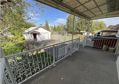 a porch of a house with a fence at Résidence J'aime in Laval