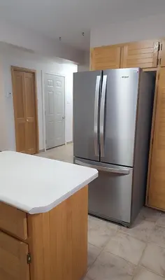 a kitchen with a stainless steel refrigerator at Résidence J'aime in Laval