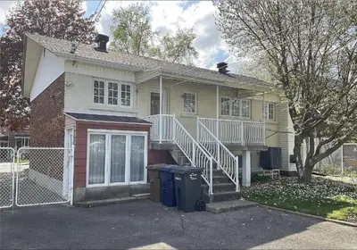 a house with a staircase in front of it at Résidence J'aime in Laval