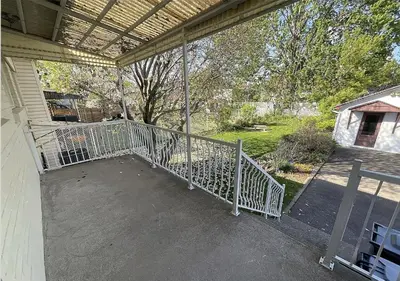 a screened porch with a fence and a yard at Résidence J'aime in Laval