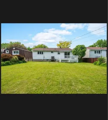 a large yard with a house and a house at Lumiere dOrient in Brossard