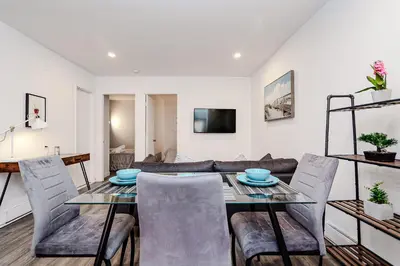 a dining room and living room with a table and chairs at Séjour pratique à Montréal, proche du vieux port in Montréal