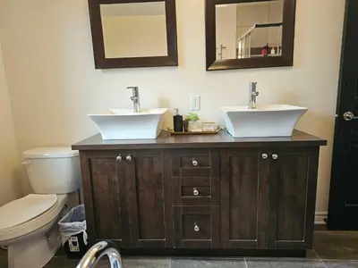 a bathroom with two sinks and a toilet at 4BR Townhouse 5-Min to DIX30 20-Min to Downtown in Brossard