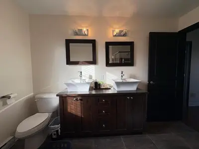 a bathroom with two sinks and a toilet at 4BR Townhouse 5-Min to DIX30 20-Min to Downtown in Brossard
