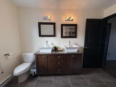 a bathroom with two sinks and a toilet at 4BR Townhouse 5-Min to DIX30 20-Min to Downtown in Brossard