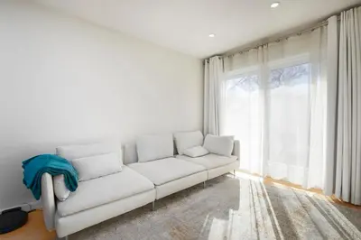 a white couch in a room with a large window at Comfort & Style in Ahuntsic in Montréal
