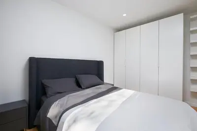 a bedroom with a large bed with white cabinets at Comfort & Style in Ahuntsic in Montréal