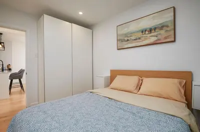 a bedroom with a bed and a painting on the wall at Comfort & Style in Ahuntsic in Montréal