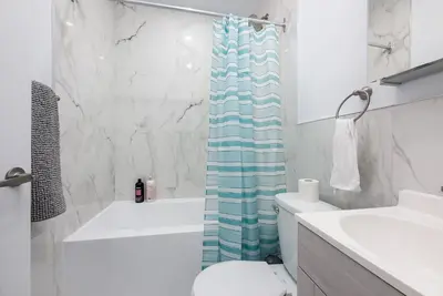 a bathroom with a toilet and a shower curtain at Downtown Montreal Lofts Quartier des Spectacles in Montréal