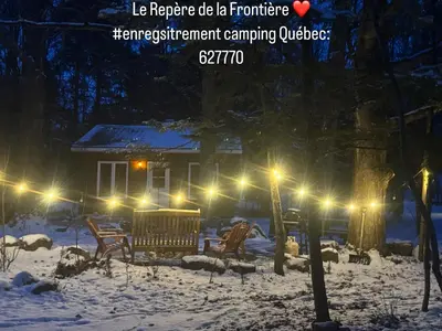 a house in the snow at night with lights at Le Richelieu in Saint-Bernard-de-Lacolle