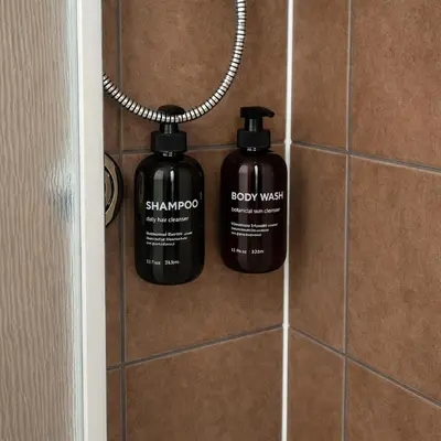 two bottles of shampoo are hanging on a wall at Fonctionnal Escape in Trendy Plateau Montreal in Montréal