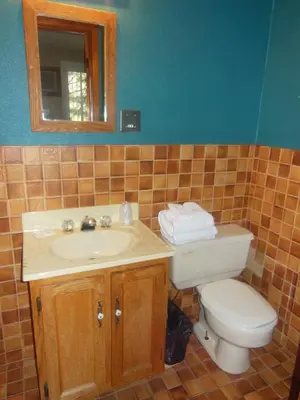 a bathroom with a sink and a toilet and a mirror at Motel Le Paysan in Montréal