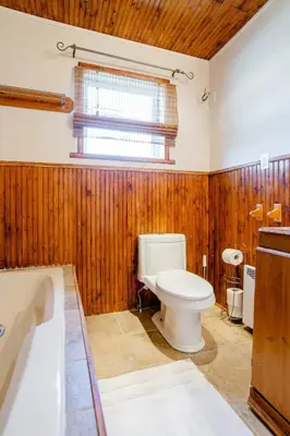 a bathroom with a toilet and a bath tub at Luxury House Near Montreal Self Check-In in Longueuil
