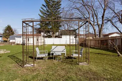 a gazebo with chairs and a table in a yard at Luxury House Near Montreal Self Check-In in Longueuil