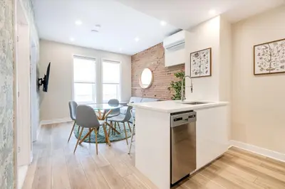 a kitchen and dining room with a table and chairs at Mont Royal Suites - M11 in Montréal