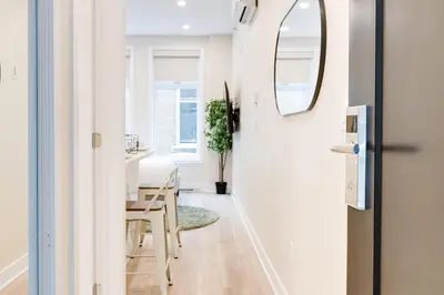 a hallway with a table and a mirror at Mont Royal Suites - M11 in Montréal