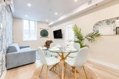 a living room with a table and chairs at Mont Royal Suites - M11 in Montréal