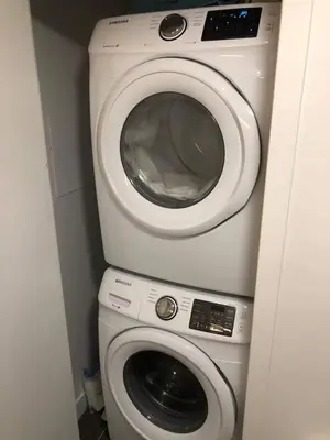 a washing machine and a washer in a bathroom at Highrise 1BDR Condo in Downtown Montreal - Long Term Stay by M11 in Montréal
