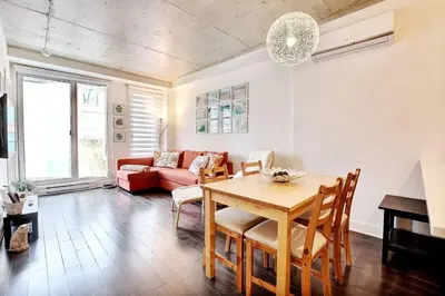 a living room with a table and a couch at Highrise 1BDR Condo in Downtown Montreal - Long Term Stay by M11 in Montréal