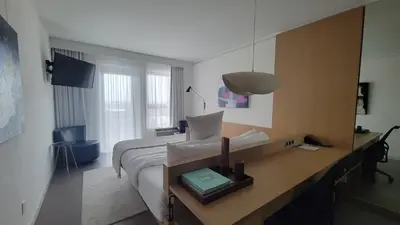 a bedroom with a bed and a desk with a mirror at chambre au centre ville de Montréal in Montréal