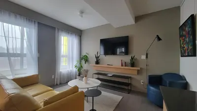 a living room with a couch and a table at chambre au centre ville de Montréal in Montréal