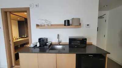 a kitchen with a counter top with a microwave at chambre au centre ville de Montréal in Montréal