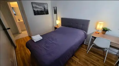 a bedroom with a purple bed and a desk and a chair at Private rooms in a shared two bedrooms apartment in Montréal