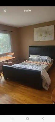 a bedroom with a large bed in a room at Very large room in Montréal