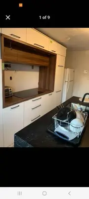 a kitchen with a dish drying rack on a counter at Very large room in Montréal