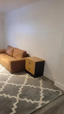 a living room with a bed and a table at small modern 2 bedrooms in Montréal