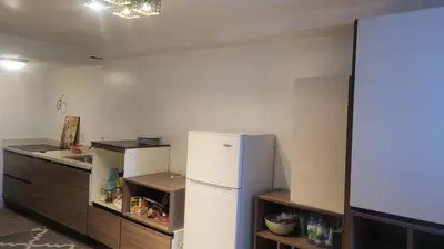 a kitchen with a white refrigerator and a counter at small modern 2 bedrooms in Montréal