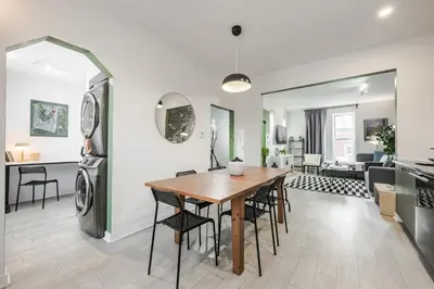 a dining room and living room with a table and chairs at 4 bedrooms 2 floors Fully Renovated Apartment in Montréal