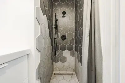 a shower with a shower curtain in a bathroom at 4 bedrooms 2 floors Fully Renovated Apartment in Montréal