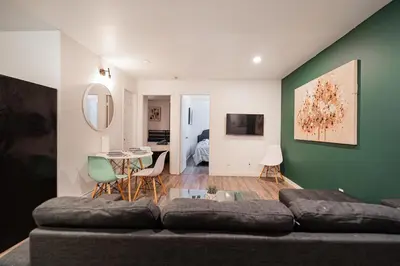a living room with a couch and a table at Griffintown Urban Nest 2BR Comfort in Montréal