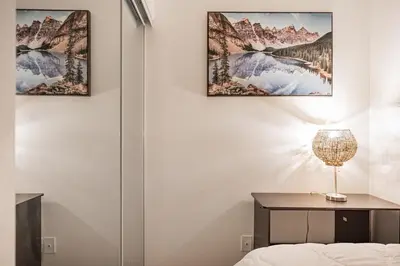 a room with a table and two paintings on the wall at Griffintown Urban Nest 2BR Comfort in Montréal